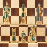 Hand painted chess pieces with a Crusades theme, including figures like King Richard the Lionheart and Saladin, displayed on a chess board.
The chess set concentrates particularly on the Third great Crusade led by King Richard I of England, who in 1189 joined King Philip II of France in an effort to recapture the holy city of Jerusalem. King Richard, with 8000 troops, seized Cyprus and some cities on the Palestinian coast, but ultimately failed to dislodge the Muslim leader Saladin from Jerusalem.